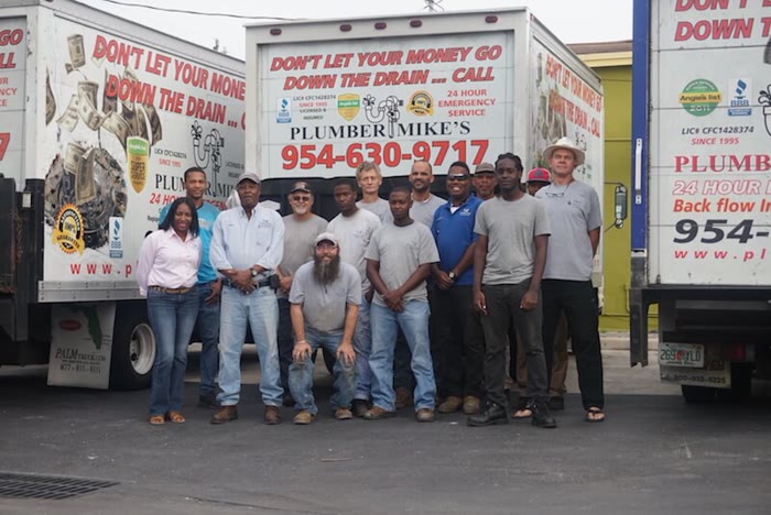The Plumber Mike's crew standing in front of their trucks