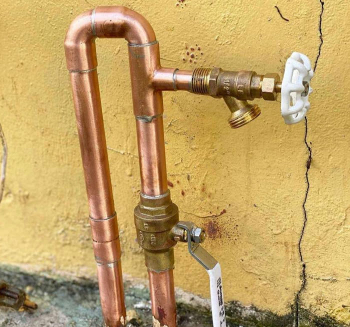 New copper piping with a brass shut-off valve and hose bib