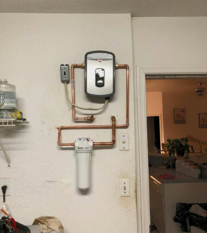 Wall-mounted tankless water heater with copper lines