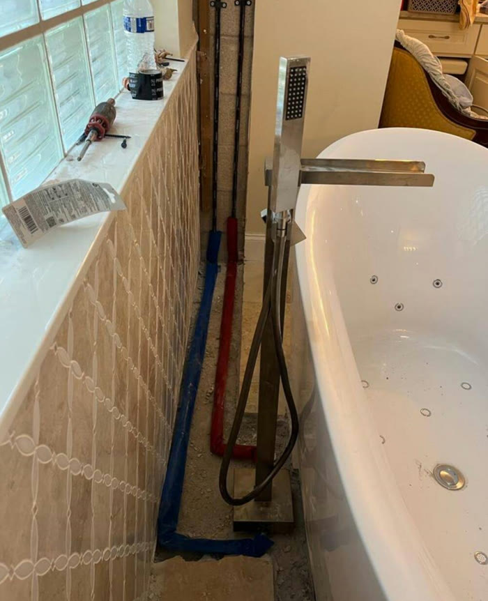 Soaking tub with new rough-in plumbing during a bathroom remodel